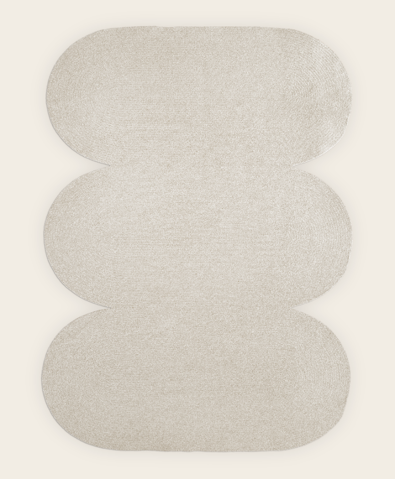 Light grey sustainable wool area rug in curvy shape